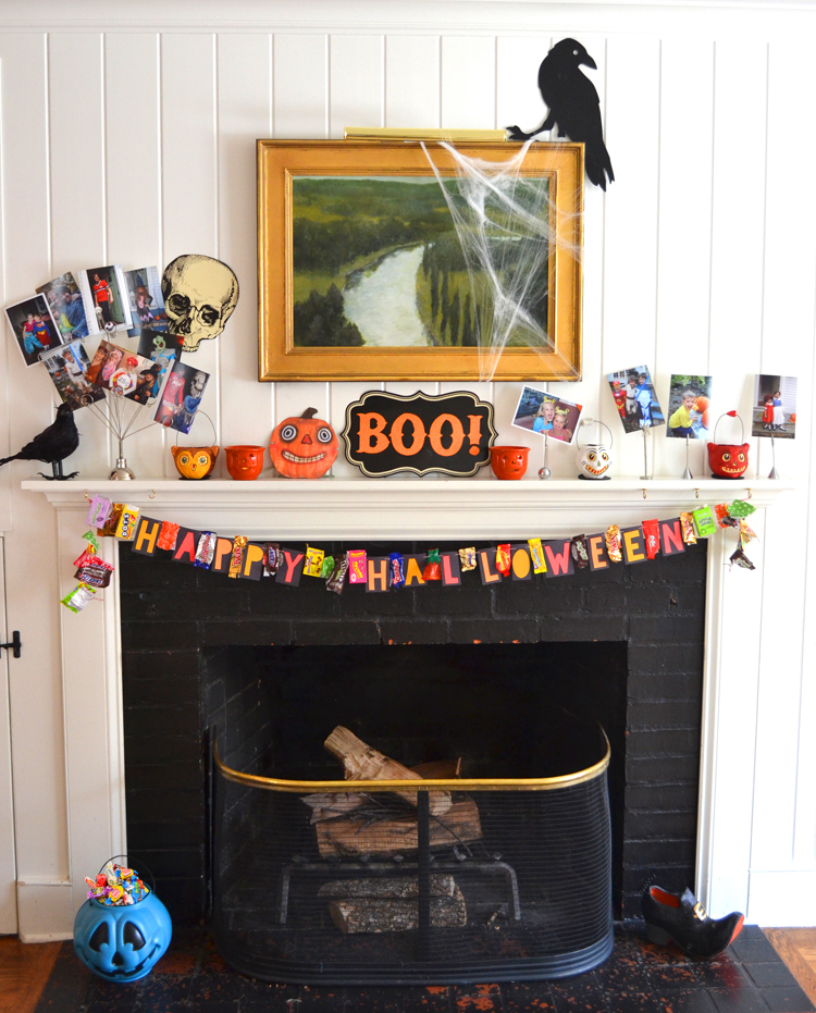 Halloween decorations on a mantle featuring a DIY candy wrapper garland