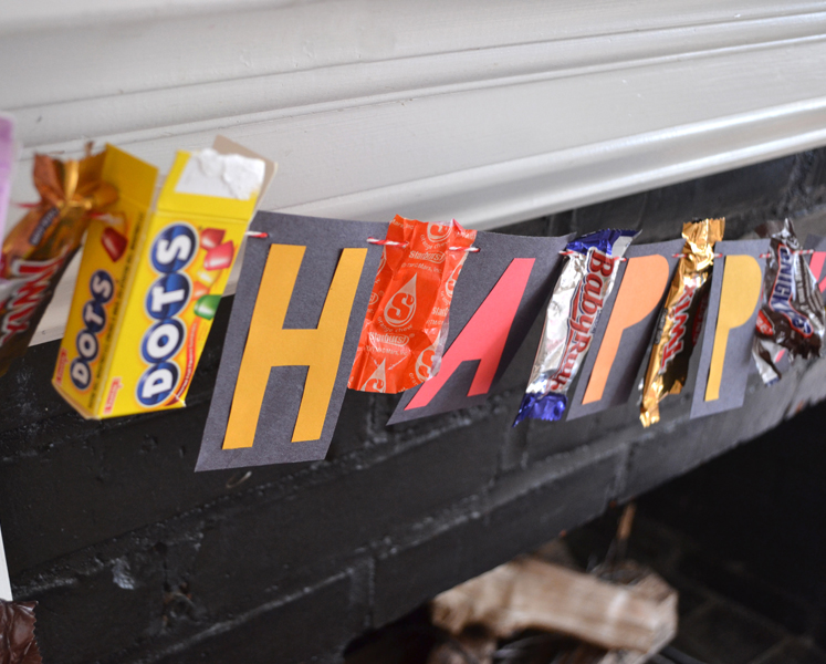 close up of Halloween candy wrapper garland on mantle