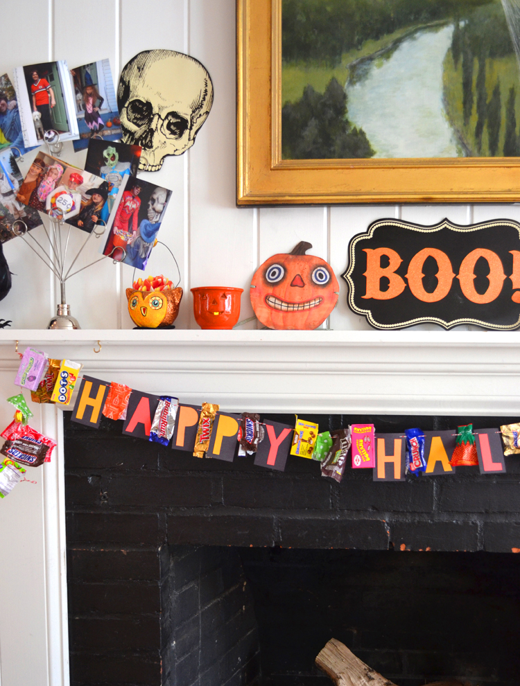 candy wrapper garland hanging on mantle with Halloween decor