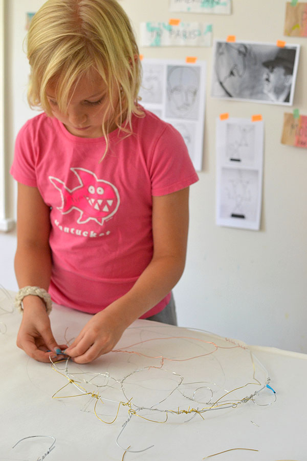 kids make faces from wire in the style of American artist and sculptor Alexander Calder