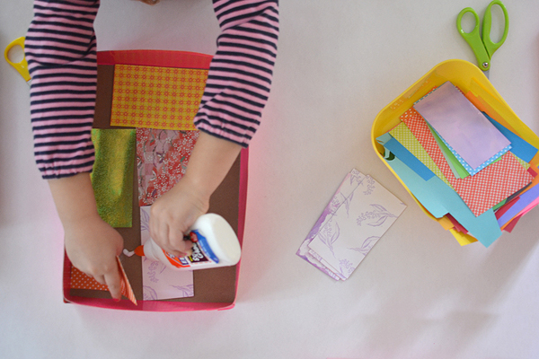 Children collect small things from their homes to make a collage.