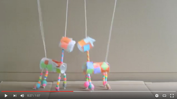 YouTube video of children making marionettes from TP rolls, tissue paper, and painted beads.