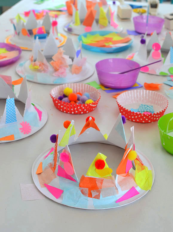 Paper plates are cut into crowns for children to collage into party hats.