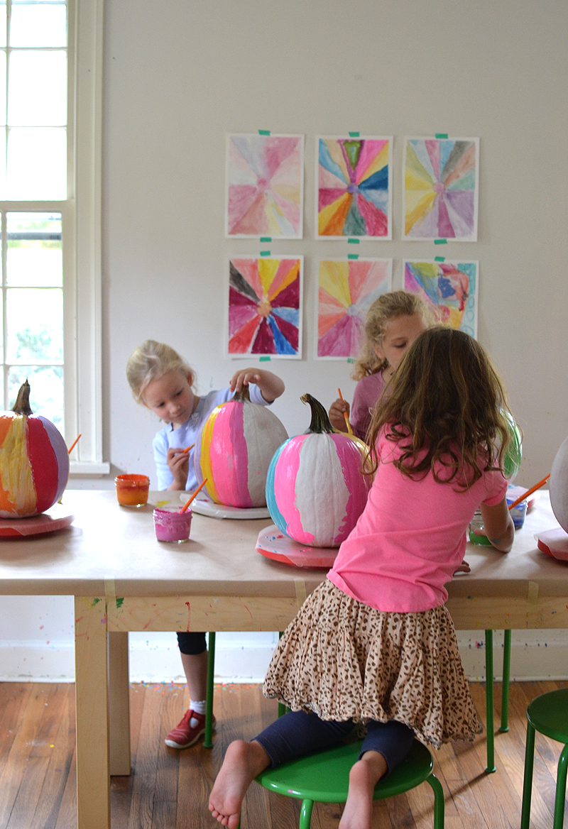 After using this one trick, the kids paint vibrant and colorful pumpkins using acrylics and collaging with tissue paper.