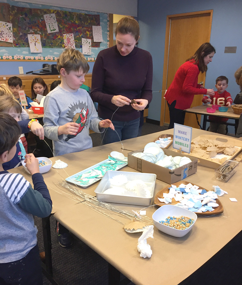 kids make winter inspired mobiles with a collection of different materials, including wooden beads, cupcake liners, and pinecones. and don't forget the secret ingredient that will keep kids at the table forever!