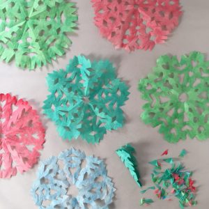 Kids paint and cut coffee filters to make these colorful snowflakes.