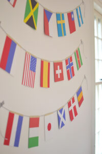 kids make world flag garland using library books and colored paper, celebrate Olympics