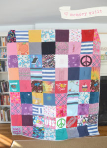 A patchwork quilt made in loving memory of Grace, with her well-loved clothes.