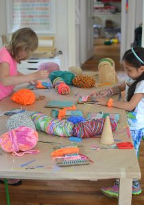 Children make small weavings with homemade cardboard looms. Perfect for ages 5 and up!