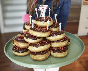Layer donuts on top of each other and add candles, the simplest birthday cake ever.