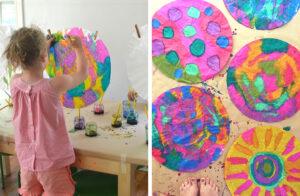 girl painting with liquid watercolor on giant coffee filter and group of painted filters on tabletop
