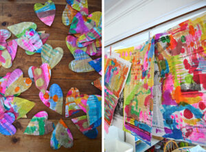 paint on newspaper using liquid watercolors and cut-out hearts with watercolor paint on them