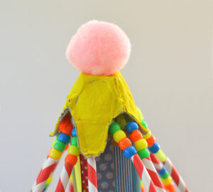 top of cardboard circus tent craft showing pom pom
