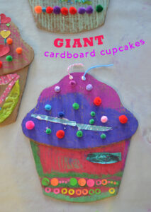 kids make Wayne Thiebauld inspired giant cardboard cupcakes with oil pastels and pom-poms