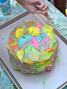 create a white cake and let the kids paint it with colored frosting