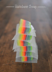 making homemade rainbow soap with kids