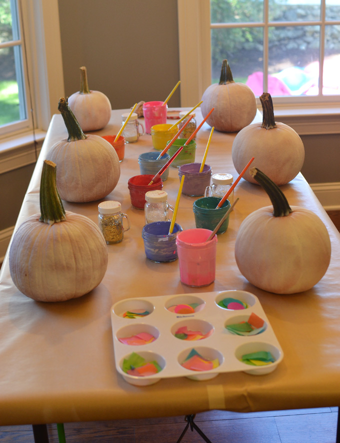 Kids paint and collage pumpkins at a birthday party.