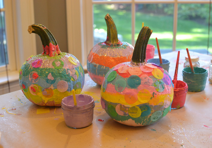 Kids paint and collage pumpkins at a birthday party.