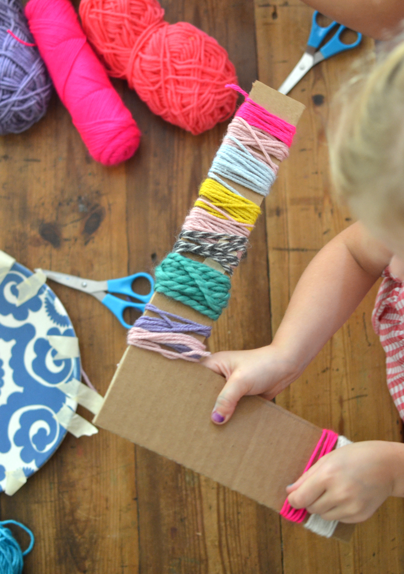 Cardboard letters wrapped with yarn made by kids.