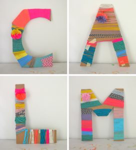 Cardboard letters wrapped with yarn made by kids.