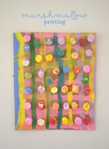 Children collaborate to make a painting from marshmallows