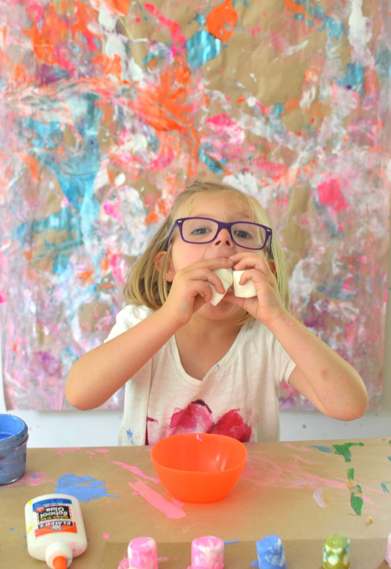 Children collaborate to make a painting from marshmallows