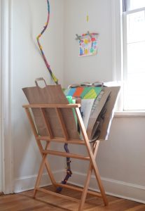 Make paper bag portfolios (with built in handles) for your children's art, then use this magazine rack to store the portfolios.