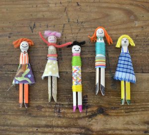 Kids make people from wooden clothespin pegs, yarn and fabric scraps.