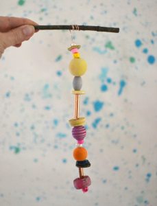 Make wooden bead mobiles using wire and twigs.