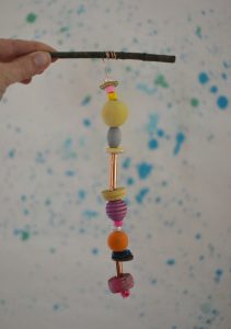 Make wooden bead mobiles using wire and twigs.