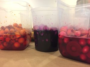Dying wooden beads with liquid watercolor.