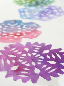 Painting snowflakes with food coloring.