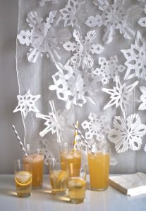 Making snowflakes from coffee filters and cupcake liners.