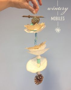 Kids make mobiles from cupcake wrappers and pinecones.