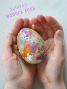Children paint gorgeous wooden eggs for Easter.