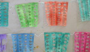 Kids paint and cut coffee filters to make this colorful Cinco de Mayo garland.