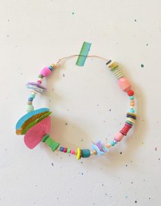 Kids make wreaths and crowns from cupcake liners, beads, and wire.