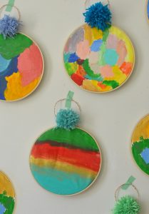Acrylic painting with kids on fabric, framed with an embroidery hoop.