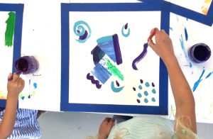 How to make layered abstract paintings with kids using warm and cool colors and a little collage.