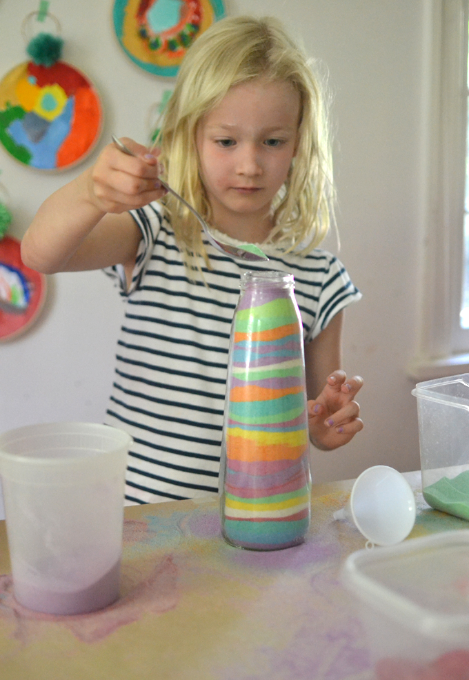 Dye sand from the beach for kids to make sand art in tall, pear juice bottles.