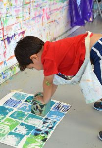 Collagraph printing with kids using wooden blocks to create a quilt pattern.