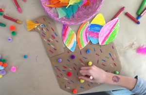 Kids make the turkey craft from cardboard at a birthday party. Great art idea for Thanksgiving, too!