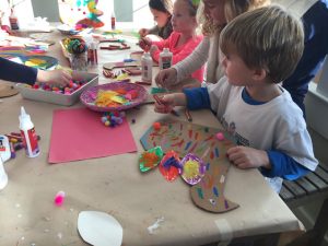 Kids make the turkey craft from cardboard at a birthday party. Great art idea for Thanksgiving, too!