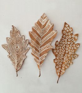 Drawing on leaves with white chalk markers is fun for all ages!