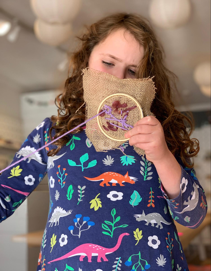 Family friendly and fuzzy embroidery with kids using a an embroidery hoop and yarn.