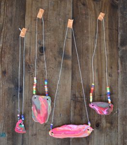 Kids make marbled polymer clay necklaces with this one awesome tool.