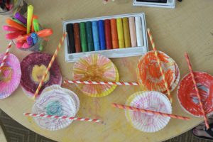 A bouquet of flowers made with cupcake liners and paper straws. A wonderful open-ended art activity for all ages.