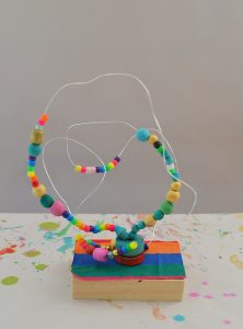 Kids make colorful beaded wire maze sculptures, reminiscent of artist Alexander Calder's work. These also are a wonderful handmade toy.