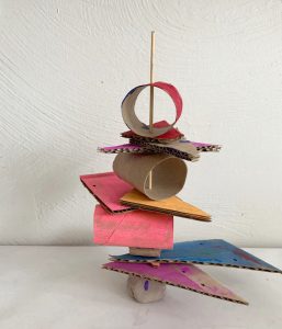 Kids use cardboard, beads, and clay to make stacked sculptures. A perfect process art experience that is great for toddlers through elementary age, and works both hand eye coordination and fine motor skills.