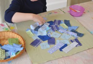 Kids make Earth Day signs using recycled and repurposed materials.